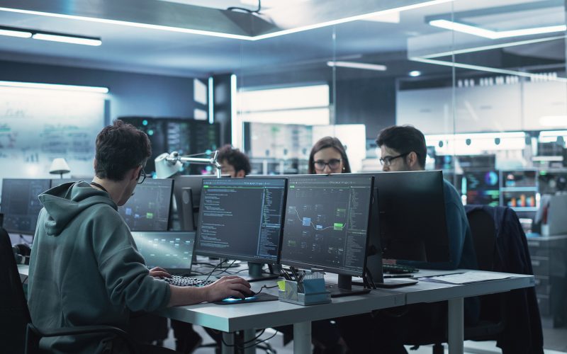 Team of Diverse Multiethnic Software Developers Working on Computers, Sitting Together in One Department. Researching and Providing Technical Support Online